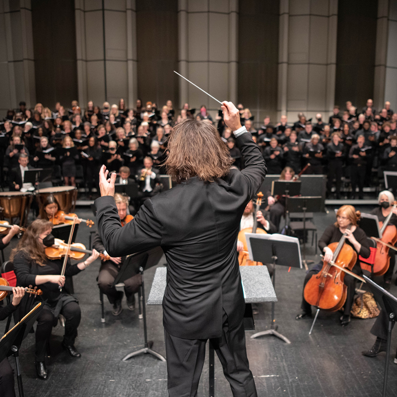 Midland Symphony Orchestra musicians performing with a conductor.