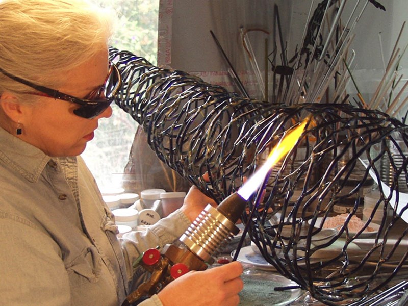 Welder using a blow torch