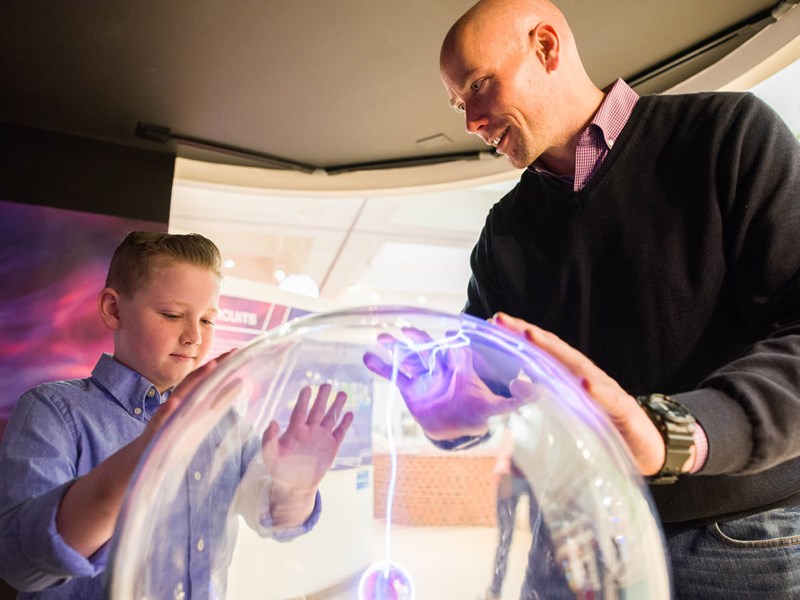 Kid and parent enjoying a museum exhibit
