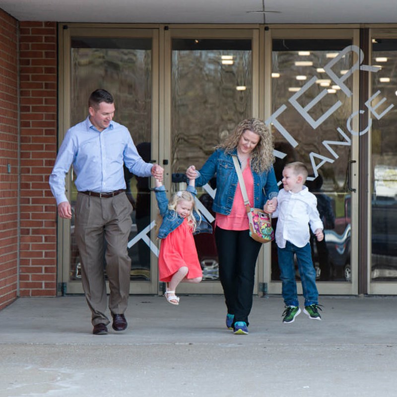Family walking outside of the Center