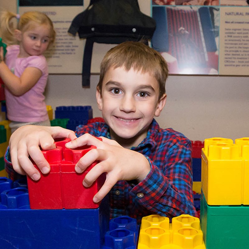 boy playing with building blocks