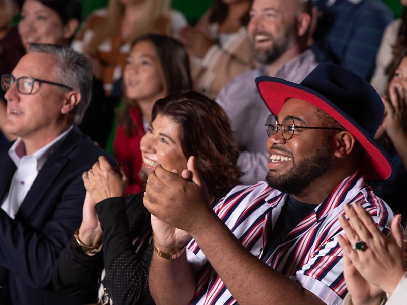 Audience members in the Little Theater applauding