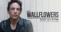 Photo of Jakob Dylan, lead singer of The Wallflowers. Text reading "The Wallflowers AUG 12 / 8 PM, Midland Center for the Arts" Photo is of standing in front of white plank wood background.